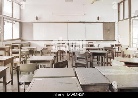 Empty disorderly classroom in the morning. Vintage style. Stock Photo