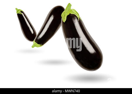 Three eggplants in a row floating in the air, on white background. Solanum melongena, also called aubergine or brinjal. Nightshade. Stock Photo