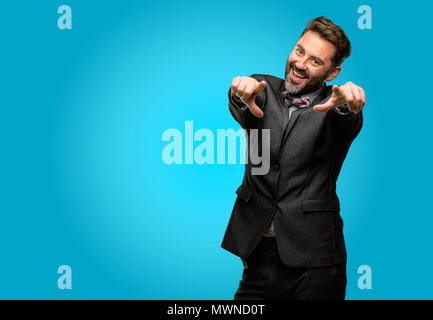 Middle age man, with beard and bow tie pointing to the front with finger Stock Photo