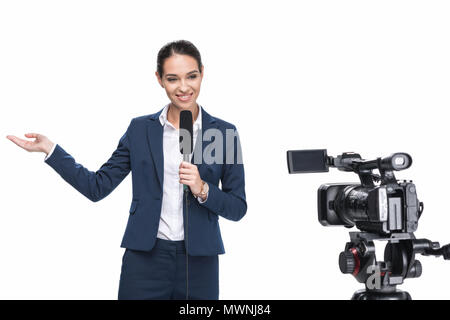 beautiful smiling female television reporter with microphone looking at camera, isolated on white Stock Photo