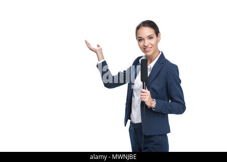 smiling female newscaster with microphone presenting something, isolated on white Stock Photo