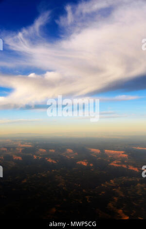 Cirrus clouds seen from airplane with Grand Canyon below at sunset, Grand Canyon, AZ, USA Stock Photo