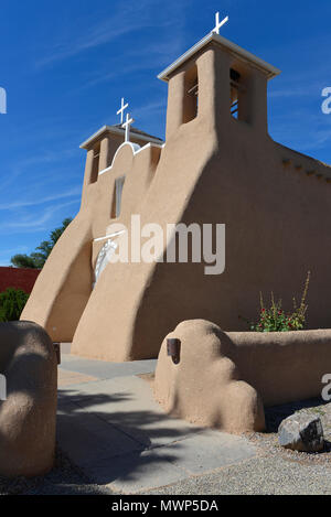 San Francisco de Asis Mission Church, side view of the south entry elevation, depicting Spanish Colonial adobe architecture (1772-1816), Taos, NM, USA Stock Photo