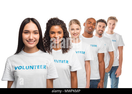 young multiethnic group of volunteers standing in row and looking at camera isolated on white Stock Photo