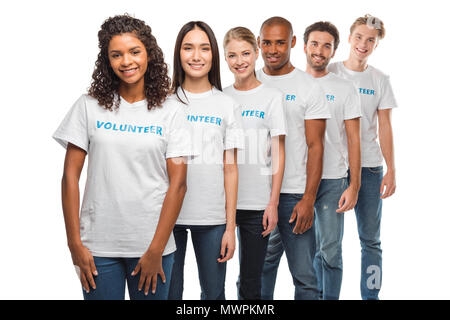 happy multiethnic group of volunteers standing in row and looking at camera isolated on white Stock Photo