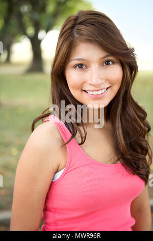 Young Hispanic girl smiling outside. Stock Photo