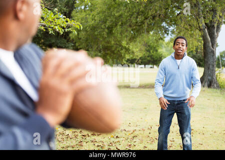 Father and son playing football. Stock Photo