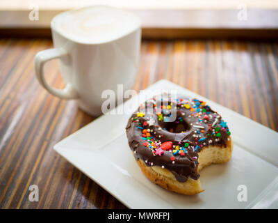 A chocolate donut with sprinkles from Picnic Too, a popular cafe and restaurant in Victoria, British Columbia, Canada. Stock Photo