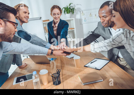 business team shaking hands over table at office space Stock Photo