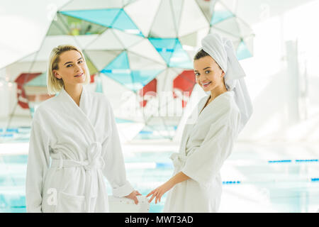 beautiful young women in bathrobes at spa center Stock Photo