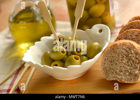 pitted olives in the white bowl - closeup Stock Photo