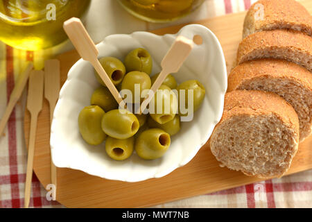 pitted olives in the white bowl - closeup Stock Photo
