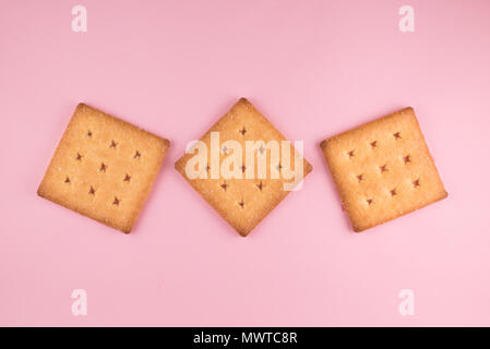 top view of three sugar cracker isolated on pink background. food and snack concept Stock Photo