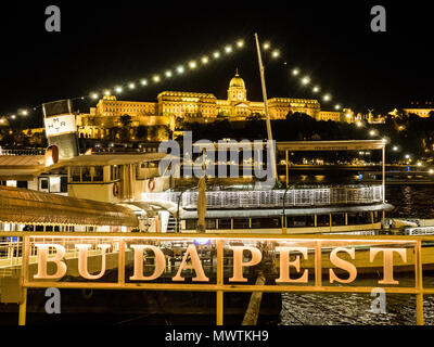 Budapest on the River Danube at night, with Buda Royal Palace aka Buda Castle in the background, Hungary. Stock Photo