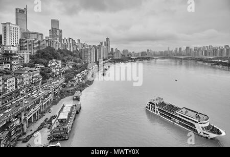 Chongqing, China - October 03, 2017: Cruise ship leaves harbor. The city is an economic centre of the upstream Yangtze basin. Stock Photo