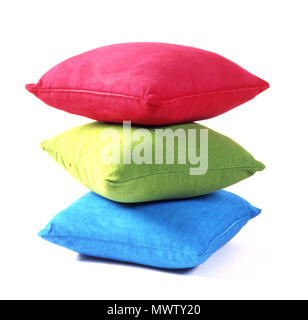 STUDIO IMAGE OF THREE COLOURFUL CUSHIONS PILED ONE ON TOP OF THE OTHER AGAINST A WHITE BACKGROUND. Stock Photo
