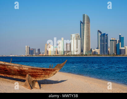 Traditional boat in the Heritage Village with city skyline in the background, Abu Dhabi, United Arab Emirates, Middle East Stock Photo