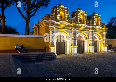 Illuminated entrance gate of the chapel El Calvario near Antigua at dusk, Guatemala, Central America Stock Photo