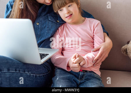 Mother and daughter with down syndrome using laptop Stock Photo