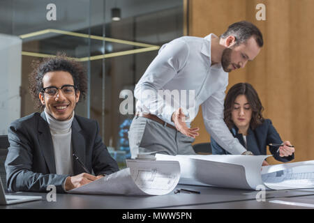 team of young architects discussing building plans Stock Photo