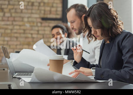 team of architects working on building plans at modern office Stock Photo