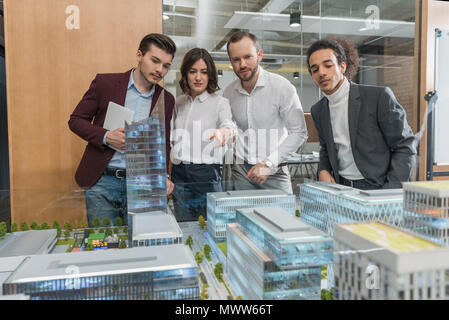 group of architects discussing building models at office Stock Photo