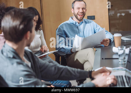 team of happy businesspeople laughing and working together at office Stock Photo