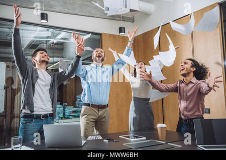 group of successful businesspeople throwing up documents at office Stock Photo