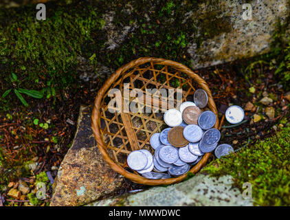 Praying coins at forest on Mount Koya (Koyasan) in Kansai, Japan. Stock Photo