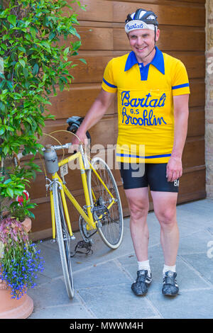 Cyclist with bike bicycle at Montisi taking part in the Eroica Montalcino, Siena, Tuscany, Italy in May Stock Photo