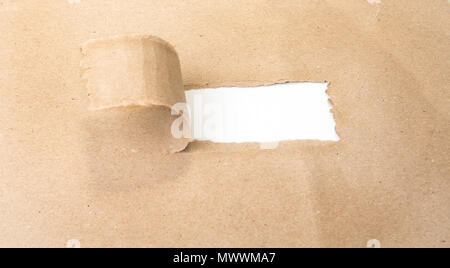 Blank torn brown paper revealing new challenges Stock Photo