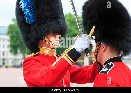 London, UK. 2nd June 2018. A superior inspects one of his soldiers' uniform detail and checks the posture. Londoners and tourists enjoy watching the procession and display of pageantry by troops from the Household Division at The Colonel's Review of Trooping the Colour on the Mall in Westminster. The Colonel's Review is the second and final full public rehearsal of Trooping the Colour, one week before the Queen's Birthday Parade. It takes place along The Mall and at Horse Guards Parade. Credit: Imageplotter News and Sports/Alamy Live News Stock Photo