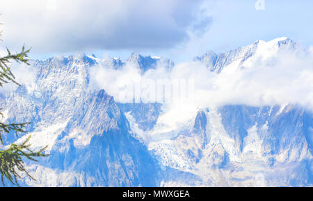 Zoom image of a large mountain with fog covered in summer nature background Stock Photo