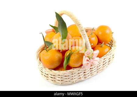 Bunch of fresh tangerines oranges on basket, Fresh orange in rattan baskets gift for Chinese New Year in concept isolated white background. Stock Photo