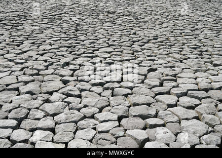 cobblestone background with uneven natural stone paving Stock Photo