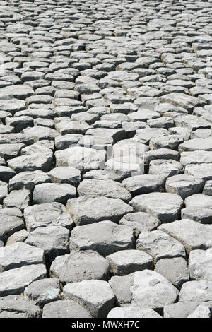 cobblestone background with uneven natural stone paving Stock Photo