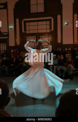 whirling dervishes dancing in traditional turkish dervish costume in istanbul Stock Photo