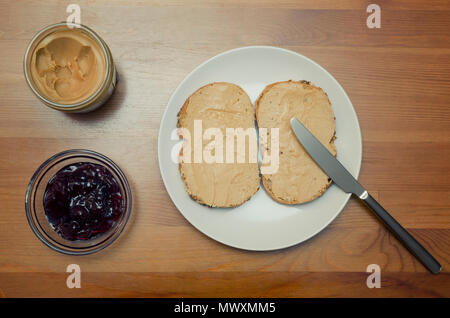 Peanut Butter, Cherry Jam And Bread Slices For Breakfast Stock Photo