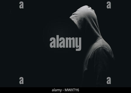 side view of unrecognizable man in man standing isolated on black Stock Photo