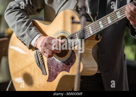 Closeup of man's hands playing acoustic guitar. Musical concept. Stock Photo