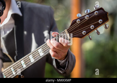 Closeup of man's hands playing acoustic guitar. Musical concept. Stock Photo