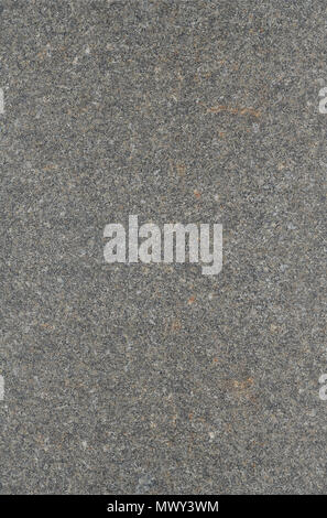 The texture of solid granite tiles. Hard and slippery gray granite surface with a relief discharge when exposed to sunlight Stock Photo