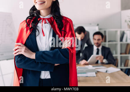 cropped image of super businesswoman in cape standing with crossed arms Stock Photo