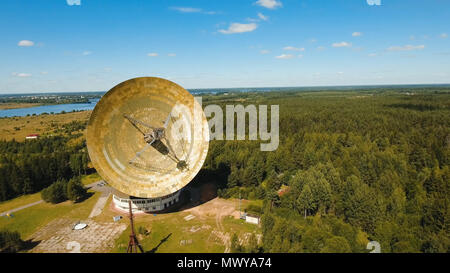 Radio astronomy observatory located in the forest. Aerial view Giant radio telescop, Large satellite dish.drone footage. Stock Photo