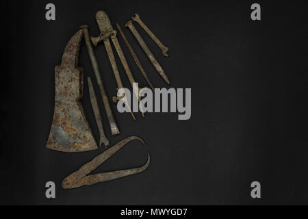 Very old and rusty tools on black background with free space Stock Photo
