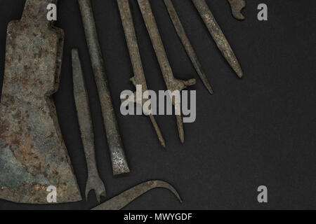 Very old and rusty tools on black background with free space Stock Photo