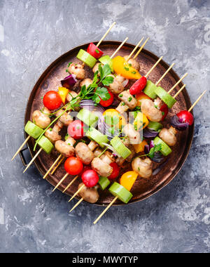 Raw diet kebab from fresh vegetables on skewers. Vegetables for grilling.American cuisine. Stock Photo