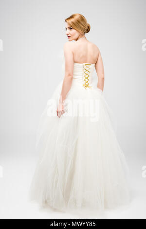 back view of bride in white wedding dress, isolated on grey Stock Photo