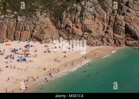 Beach at Pothcurno Bay / Cove in Cornwall, England, UK, showing the beach on a summer day. Aerial shot of holidaymakers sunbathing and swimming. Stock Photo