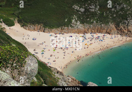 Beach at Pothcurno Bay / Cove in Cornwall, England, UK, showing the beach on a summer day. Aerial shot of holidaymakers sunbathing and swimming. Stock Photo